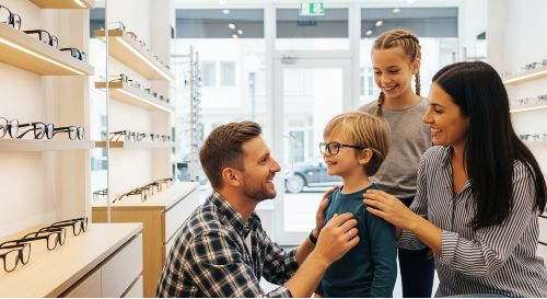 A family using their Eyemed Insurance family plan benefits to get new eyeglasses.