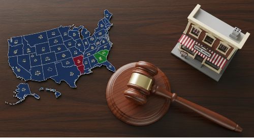 A gavel and a map of the United States, symbolizing the state-by-state legal requirement for workers' compensation.